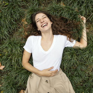 medium-shot-woman-laughing-grass