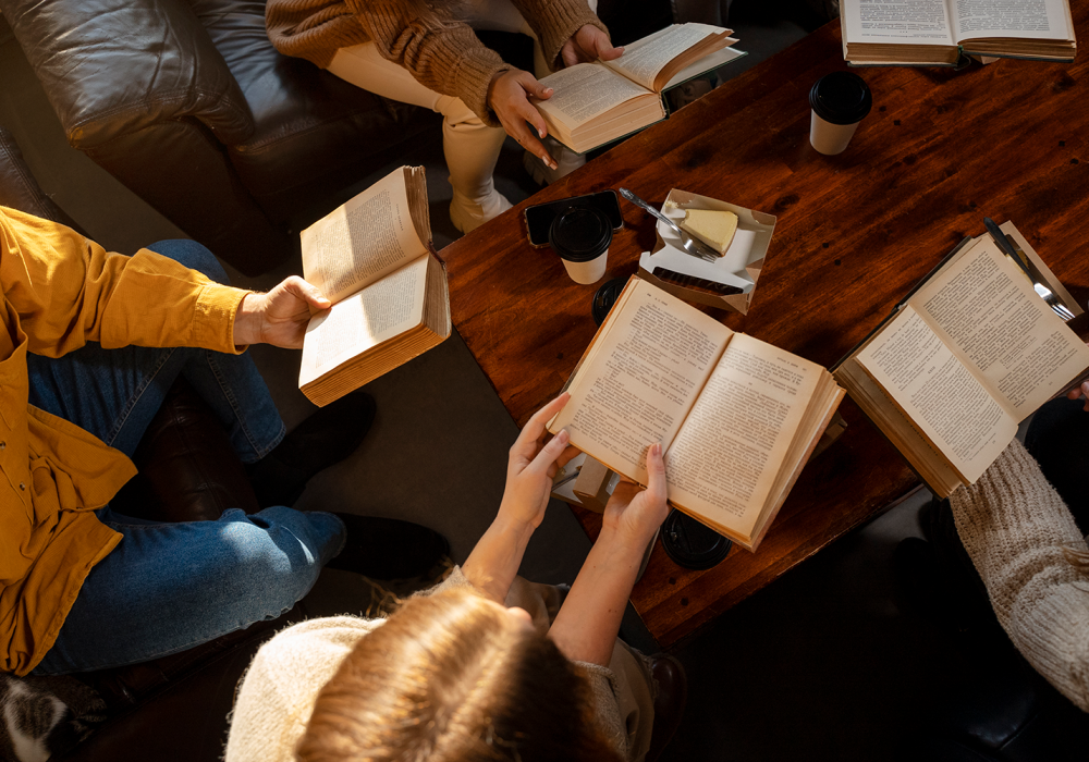 high-angle-people-reading-together